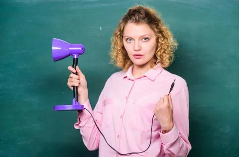 Light up process of studying. Teacher hold table lamp in hand chalkboard Foto stock