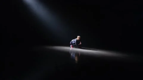 The light of the projector in the darkness turns on a dance doing a choreography Stock Footage 210539779