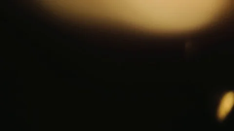 Light pulses and glows. Light leak in warm hue on dark background. Stock Footage 89688114
