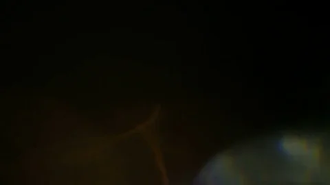 Light pulses and glows.beautiful light leak in 4K hd quality on dark background  Stock Footage 80158615