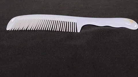 Light purple comb that has been used for a long time Stock Footage 224792313