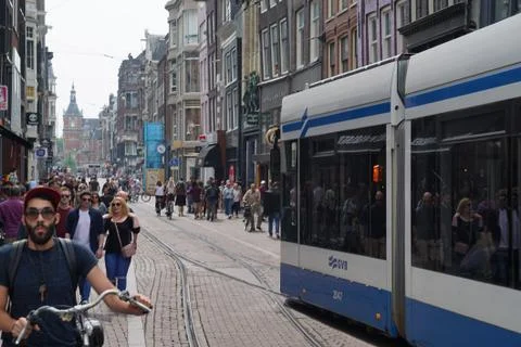 Light Rail moving through crowd in downtown Amsterdam Stock Photos