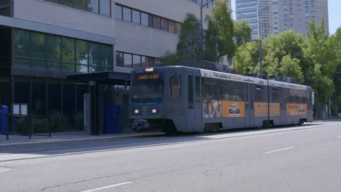 Light Rail train coming to a stop Downtown Stock Footage 249417360