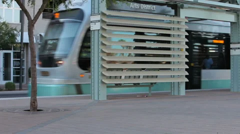 Light Rail Train Cruises by Stop Downtown Stock Footage 61839543