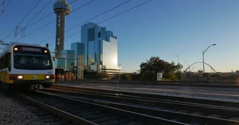 Light Rail Train in Dallas passing Reunion Tower Stock Footage 57362772