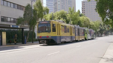 Light Rail train Driving away Downtown Stock Footage 249418136