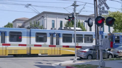 Light-Rail Train Driving By Downtown railroad crossing Stock-Footage 249417299