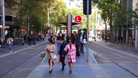 A light rail tram pulls into Chinatown station as passengers wait on the Stock Footage 340564386
