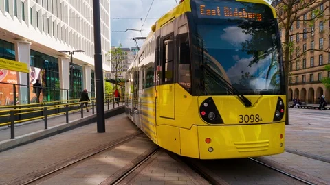 Light rail yellow tram Metrolink in city center of Manchester, UK. Time-lapse Stock Footage