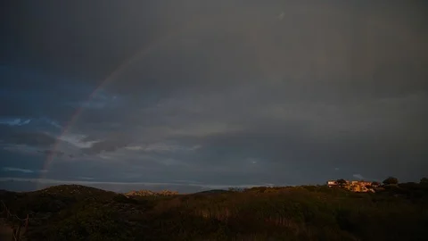 Light rain and sunset with rainbow countryside Stock Footage 106308980