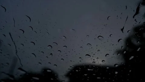 Light rain droplets on a car window glass during twilight. Stock Footage 343872952