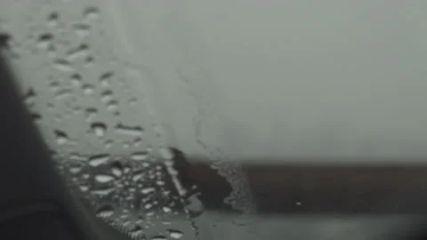Light rain on windshield wiper blade wipes water off Stock Footage 137488865