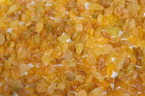 Light raisins pattern filling frame with warm golden mosaic and high detail,  Stock Photos