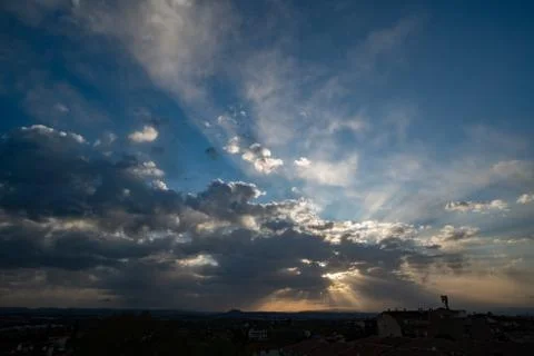 Light ray from sun behind cloud in the blue sky Stock Photos