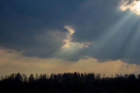 Light rays or rays of God, the yellow rays of the sun pass through the clouds Фото