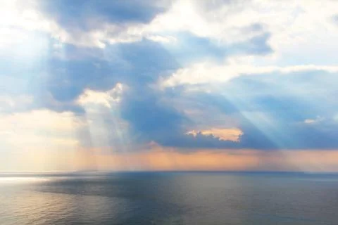 Light rays through the clouds over sea Stock-Fotos