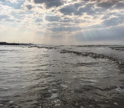 Light Rays Through Clouds over Sea Water Ocean Beach Stock Photos