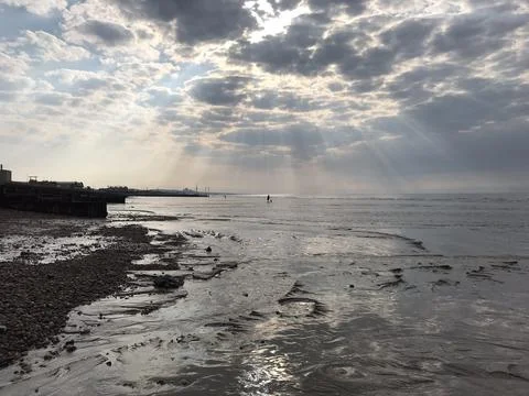 Light Rays Through Clouds over Sea Water Ocean Beach Stock Photos