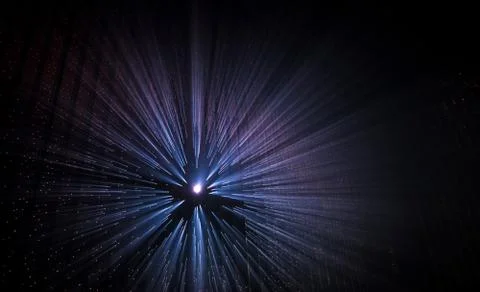 Light rays through small holes in a dark space Foto stock