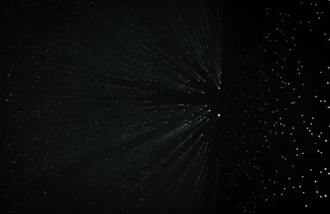 Light rays through small holes in a dark space Stock Photos