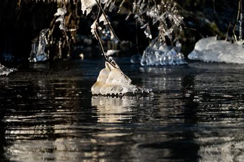 Light reflected through icicles at a river in winter time Stock Photos
