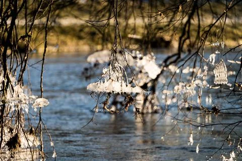 Light reflected through icicles at a river in winter time Stock Photos
