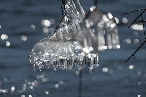 Light reflected through icicles at a river in winter time Stock Photos