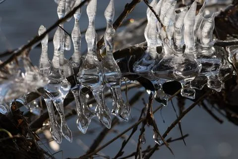 Light reflected through icicles at a river in winter time Stock Photos