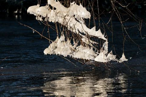 Light reflected through icicles at a river in winter time Stock Photos