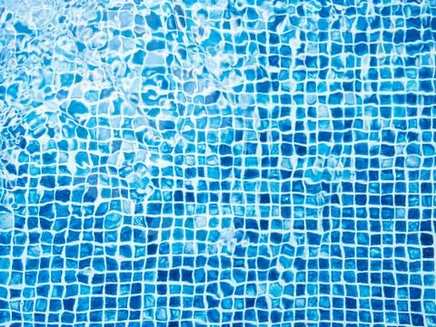 The light reflected on the top of the water surface of the pool lined with bl Stock Photos