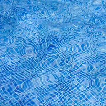 The light reflected on the top of the water surface of the pool lined with bl Stock Photos