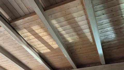 Light reflected on water illuminates a wooden ceiling inside a SPA Stock Footage 336061869