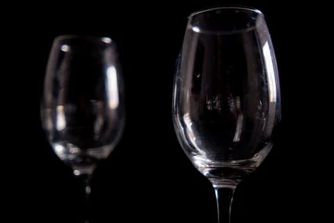 Light reflecting on empty glass goblets with black background Stock Photos
