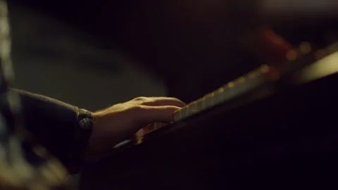 Light reflecting on a man's hands playing piano Stock Footage 279801517