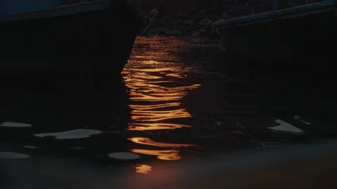 Light Reflecting Onto A River At Night With Ripples From A Fire In The Stock Footage 115800889