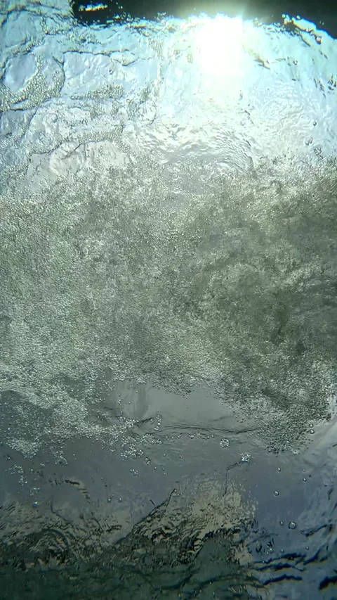 Light reflecting on water creating patterns and textures during daytime Stock Footage 332936978