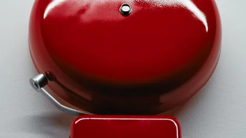 Light Reflection On A Ringing Red school Bell Stock Photos