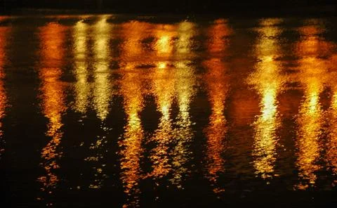 Light reflection on water at night in red yellow almost looks like fireworks Stock Photos