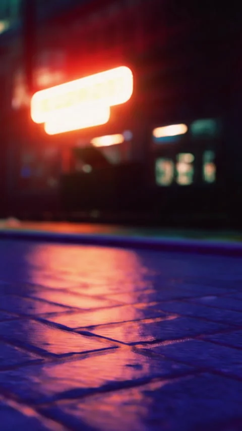 Light reflections on pavement at night near a city street Stock Footage 340882090