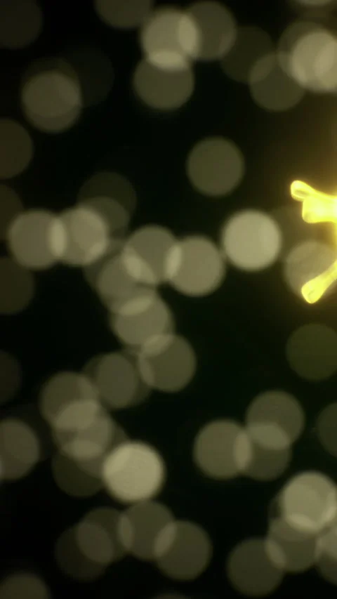 Light reflections with yellow shapes in dark background at nighttime Stock Footage 334885215