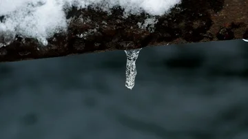 Light reflects through a melting icicle Stock Footage 85487525