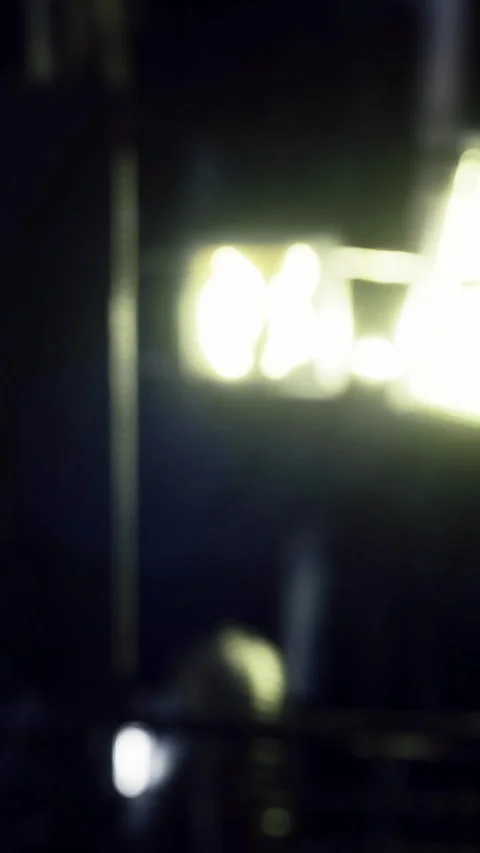 Light reflects in an urban setting at night Stock Footage 334258937