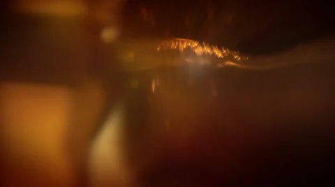 Light refracting in a rotating orange glass. Abstract background. Loop. Stock Footage 44560988