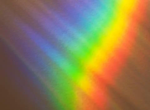 Light refraction background image. Rainbow blur reflection on stucco wall. Stock Photos