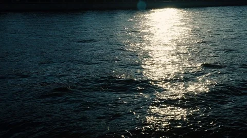 Light ripples on the surface of the river. Sun glare on the sea. Video stock 112863358