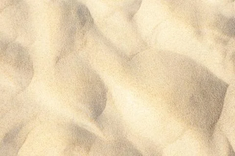Light sand pattern on beach near sea in summer background Stock Photos