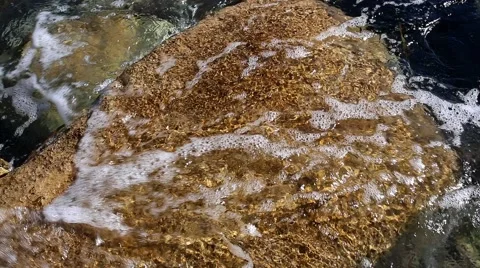 Light sea waves washed fox-color boulde Видео 68843308