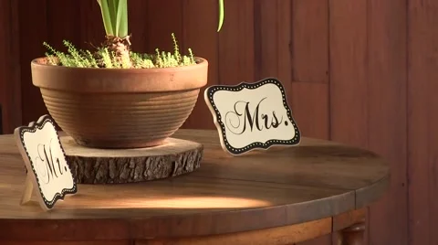 Light shimmering on a wedding table setting with mr and mrs signs Stock Footage 61854969