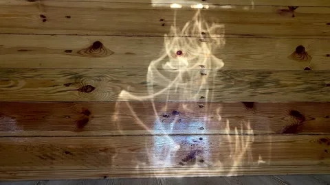 The light (shine) from the foil on the wooden surface. 4k Stock Footage 341344364