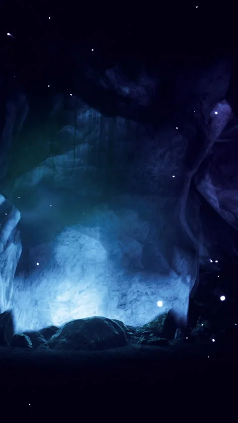 Light shines into a cave with rocks and a dark background at night Stock Footage 330272413